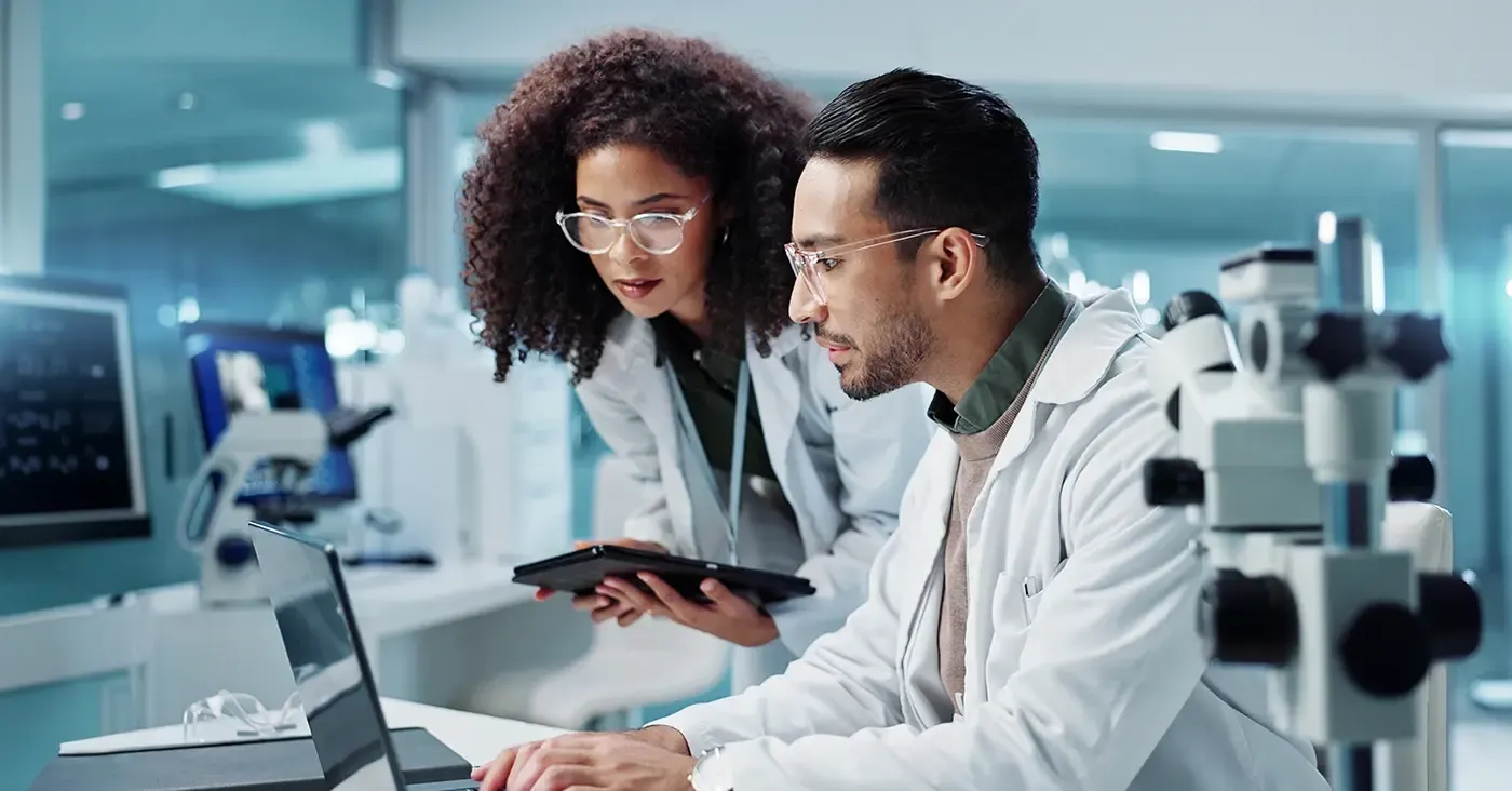 two medical professionals looking at a computer