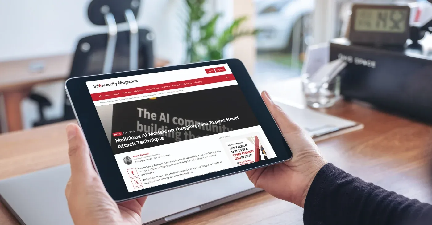 tablet being held displaying news article