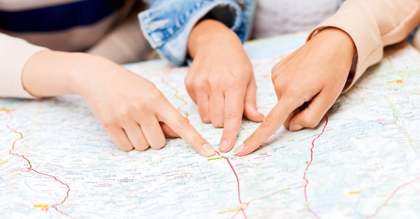 Finger on map