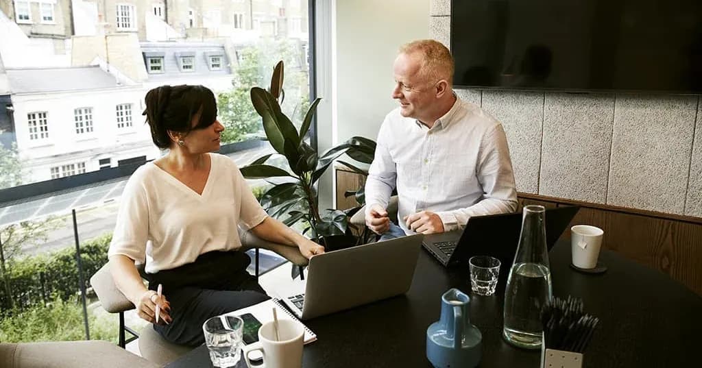 coworkers chatting at laptop